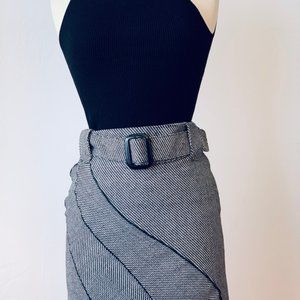 Asymmetrical fluted skirt leather-like piping